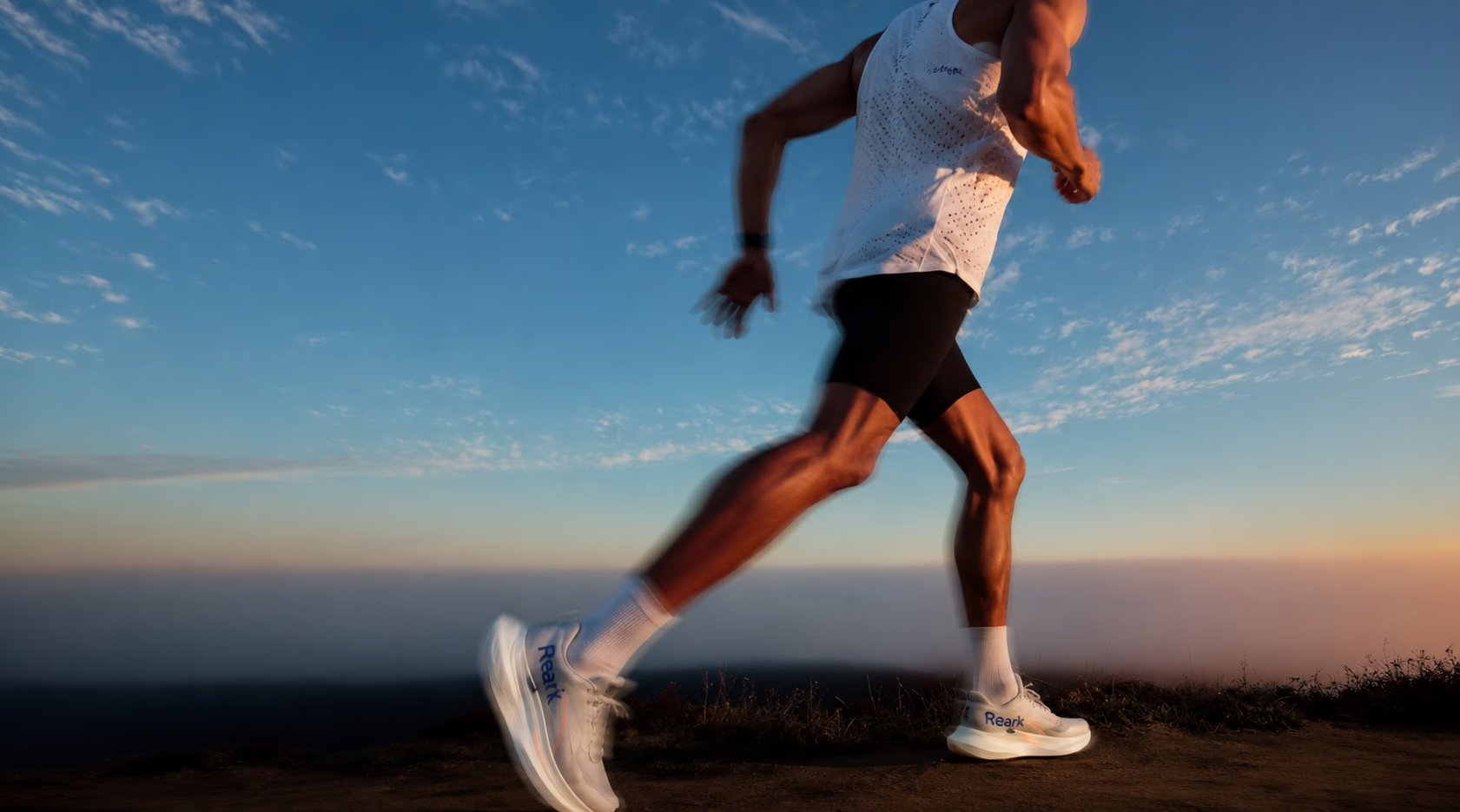 Reark athlete running at sunset